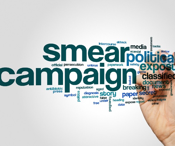 a word cloud of smear campaign and simliar terms with a hand writing them