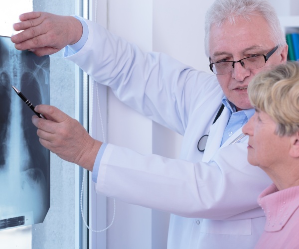 doctor going over x-rays with woman patient with lung cancer