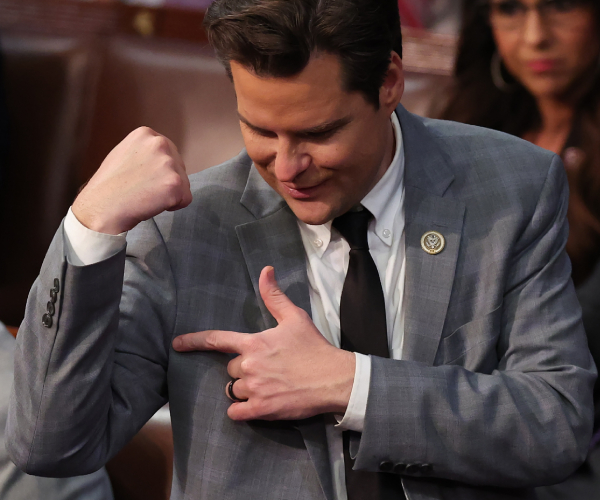 matt gates pointing to his arm while making a muscle on the floor of the house of representatives