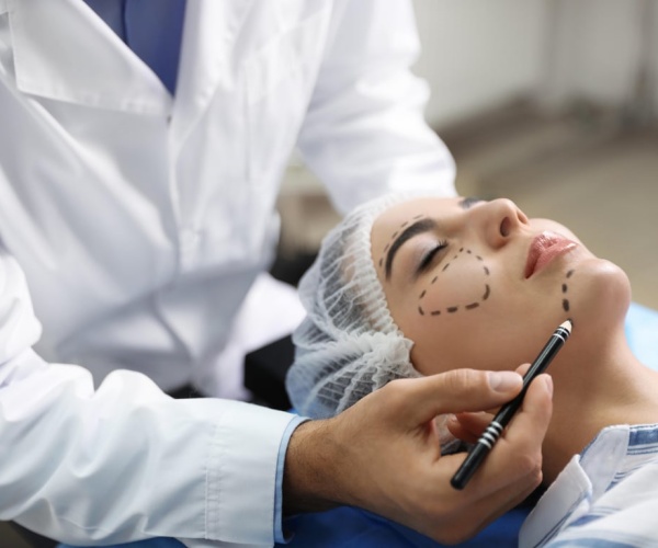 Woman in operating room about to undergo cosmetic surgery on her face