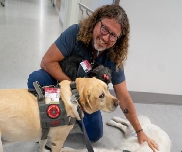 a nurse in the ICU at Wexner, with dogs from the program