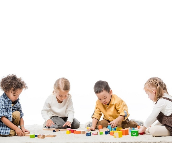 preschool children playing with blocks, puzzles