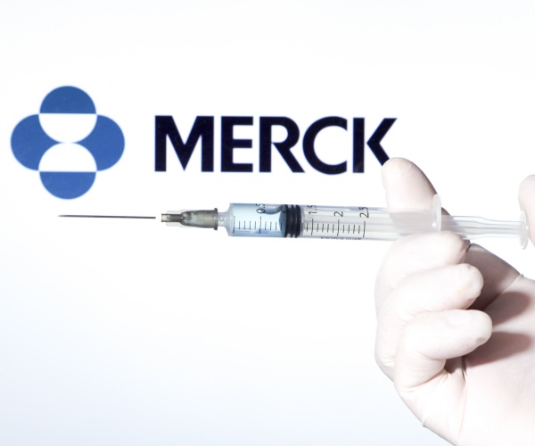 Merck logo and gloved hand holding syringe