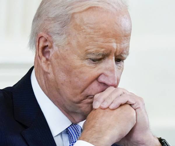 biden looking down with his head on his hands