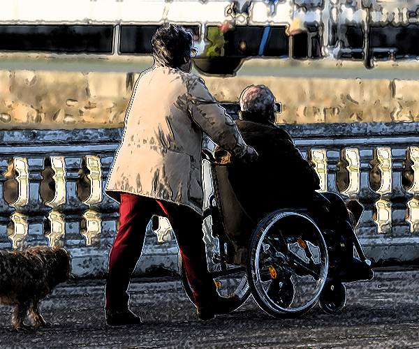 woman pushing her elderly husband in a wheelchair