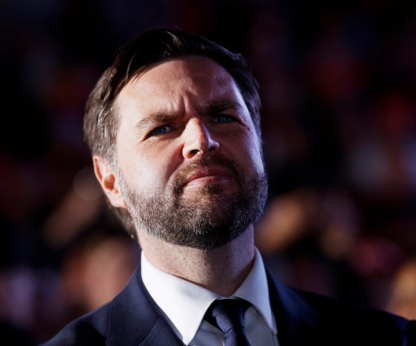 a man wearing a suit looks on