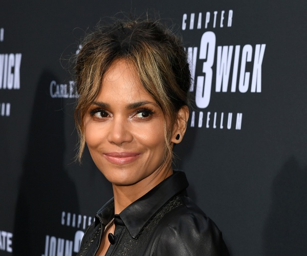 halle berry stands on red carpet