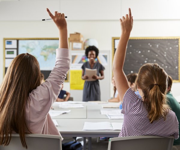 students raise their hands