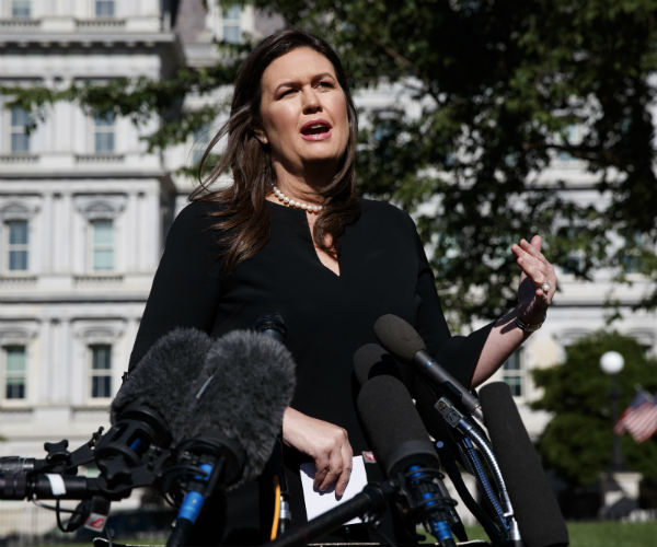 sarah sanders speaking at white house wearing a black dress