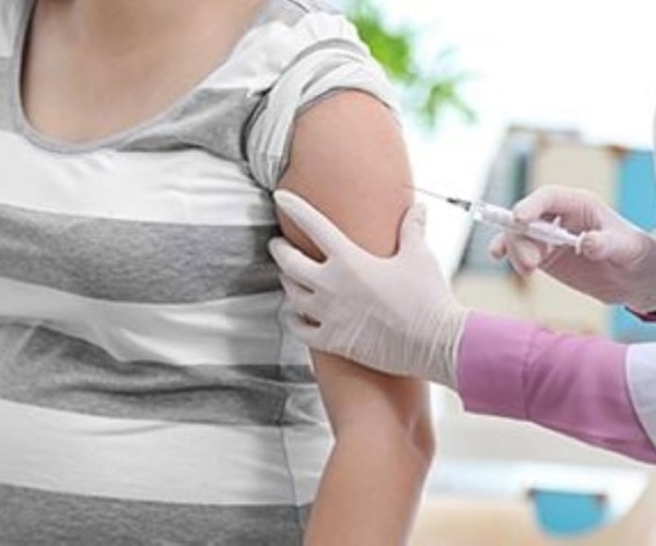 a woman receiving a vaccine