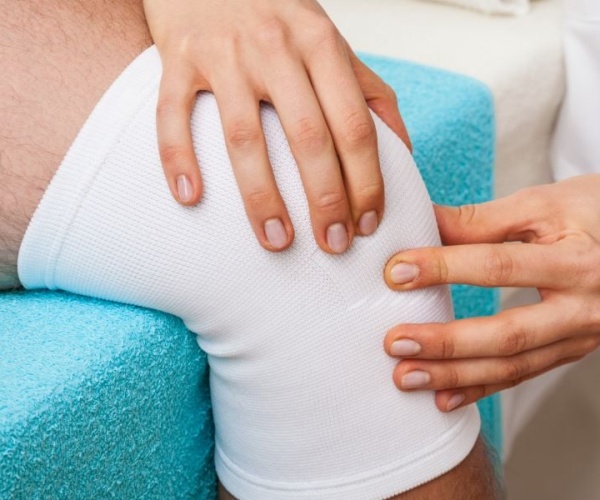 doctor examining a patient's knee