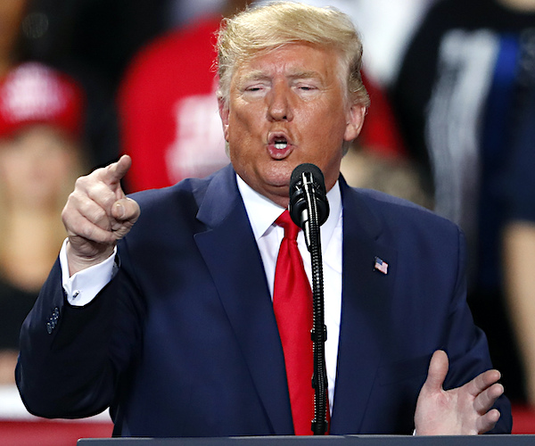 president donald trump points and exults during a campaign rally