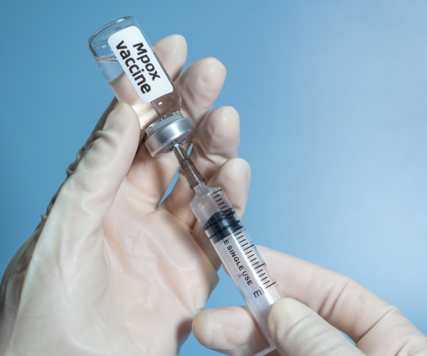 syringe in vial labeled Mpox Vaccine