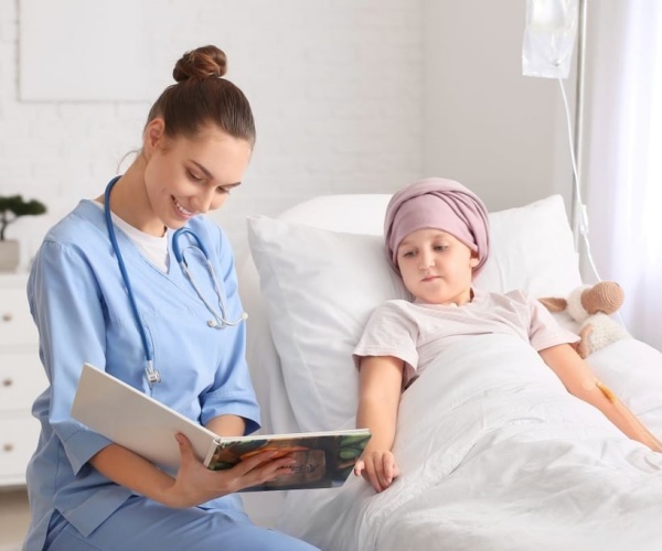 young girl with cancer in hospital with nurse 