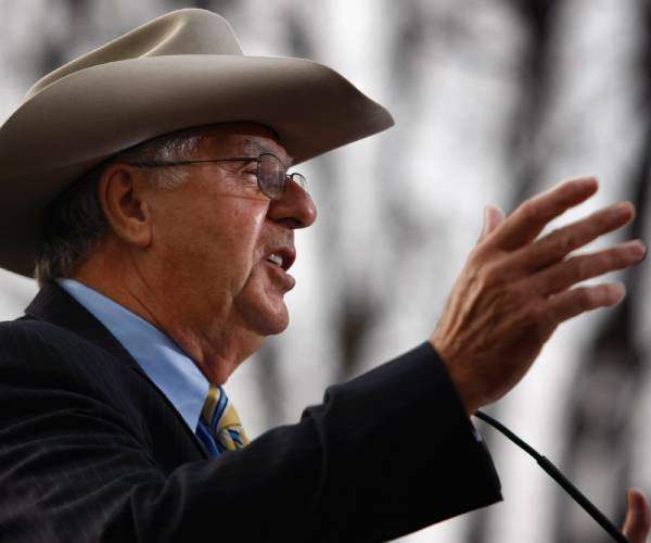 dick armey wearing a cowboy hat while making a speech