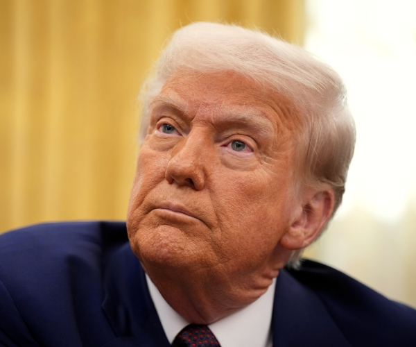 a man seated in a chair looks on