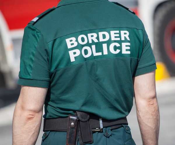 man wearing border police shirt