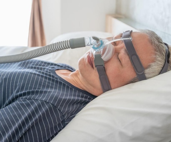 man asleep with cpap mask on