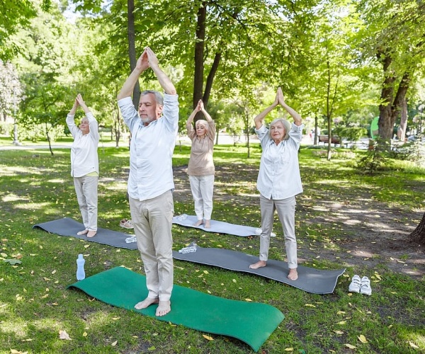 men and women in park doing qi gong or other similar ancient Chinese practice
