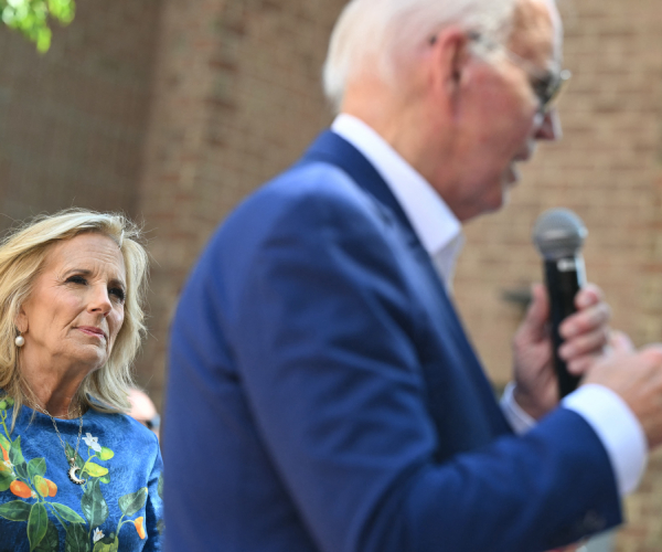 joe biden out of focus in the foreground with jill biden in focus in the background