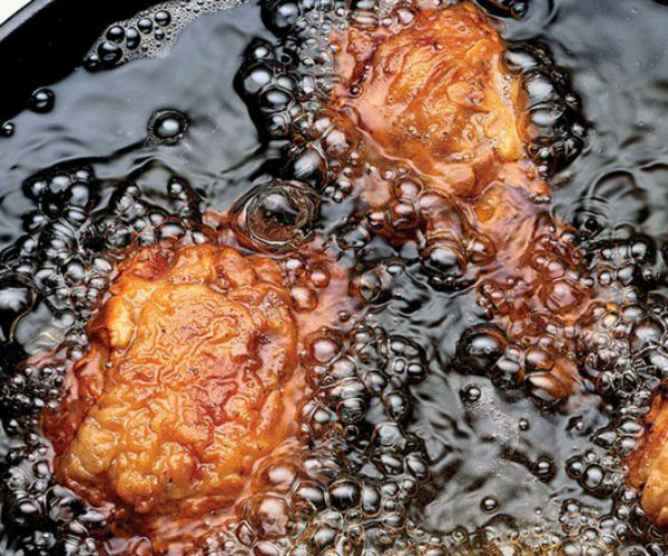 skillet fried chicken is shown in cooking oil