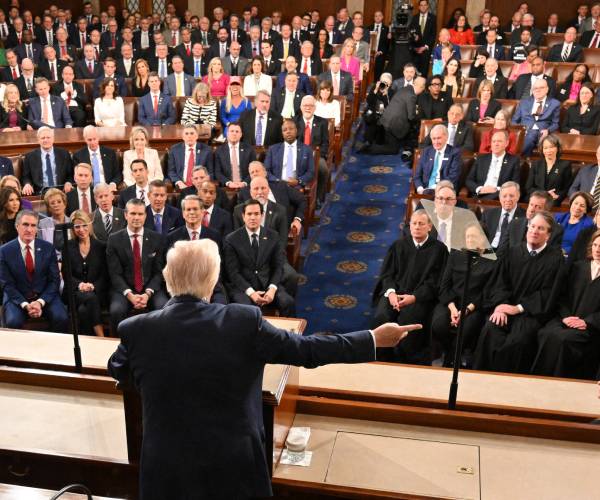 trump seen from the back with members of congress, the supreme court and his cabinet in the audience