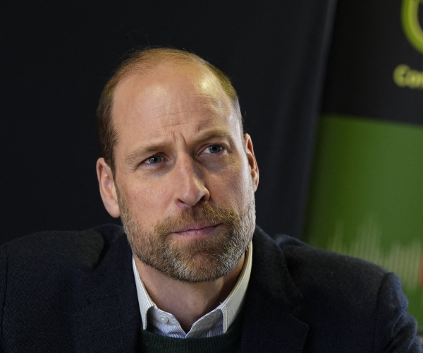 a man wearing a suit looks on