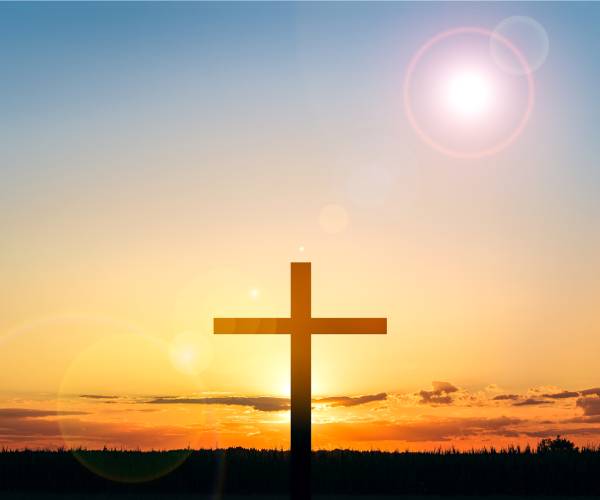 a cross and the sun on the horizon