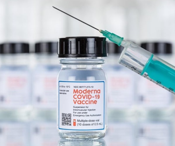 vial of Moderna COVID vaccine and syringe